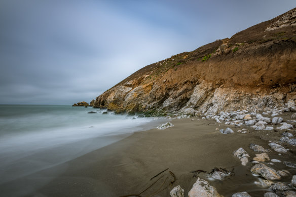 The chocolatey-brown shores of Rockaway Beach near San Francisco.