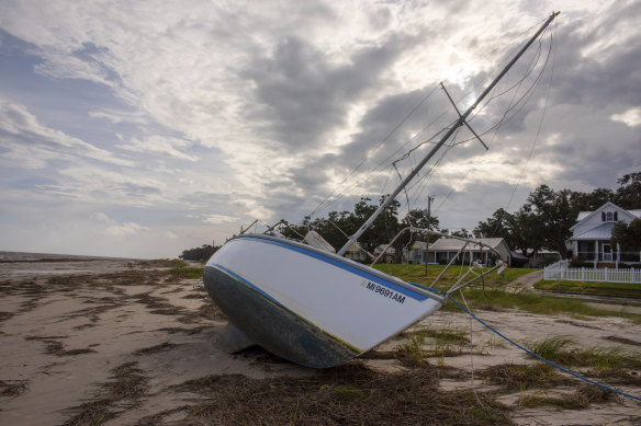 A boat rests on the beach in Bay St Louis, Mississippi after washing aground during the storm.