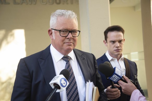 Former WA Treasurer Troy Buswell is approached by media outside a hearing into allegations he assaulted his ex-partner.