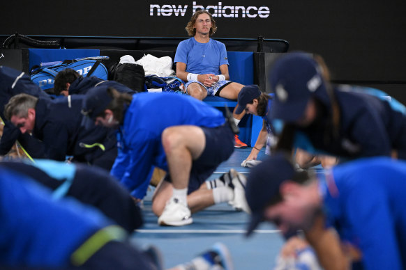 Max Purcell looks on as his match against Casper Ruud is interrupted by rain.