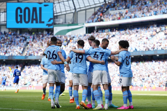 Manchester City’s Julian Alvarez, centre, celebrates after scoring his side’s opening goal during the English Premier League soccer match against Chelsea.