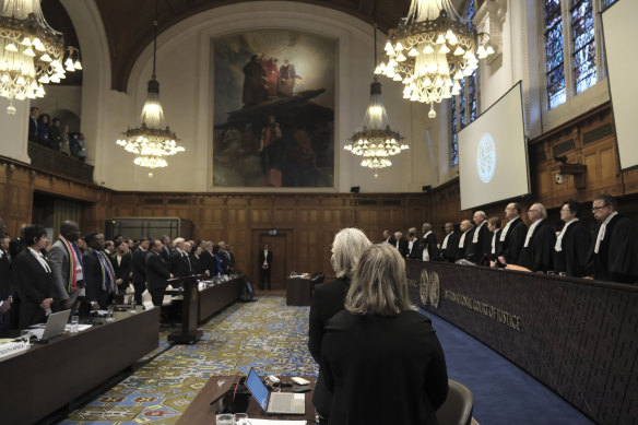 Judges and parties stand during a hearing at the International Court of Justice in The Hague, Netherlands, on Friday.