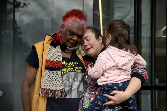 Ruby Dykes (left) and Fleur Magic Dennis, family members of Douglas “Mootijah” Shillingsworth, hug outside court on Friday.
