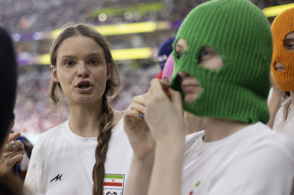 A group of young women, some wearing colourful balaclavas, who identified themselves as members of the Pussy Riot collective attend the FIFA World Cup match between Iran and the United States in Doha last month.