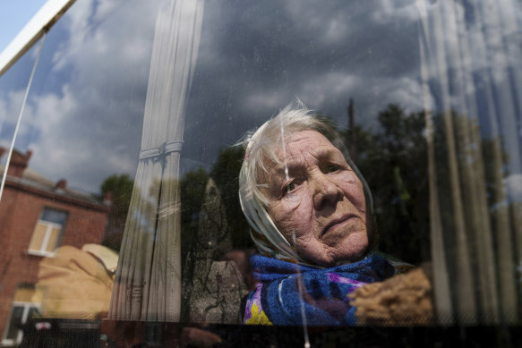Liudmila, 85, whose husband was killed at home by a Russian airstrike looks through the window of a bus after being evacuated from Vovchansk, Ukraine, on Sunday.