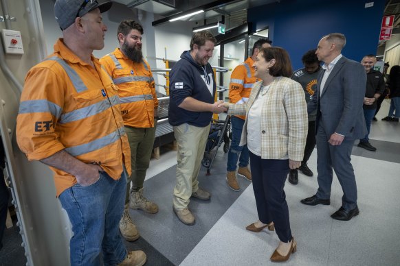 SEC Minister Lily D’Ambrosio and interim SEC chief executive Chris Miller greet workers on Thursday.