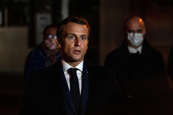 President Emmanuel Macron speaks outside the high school where Samuel Paty was murdered. 