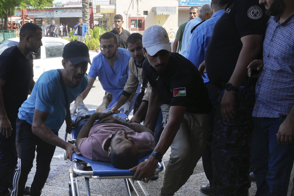 A Palestinian man wounded in Israeli air strikes on Gaza Strip is brought to al-Aqsa hospital in Deir el-Balah City, Gaza Strip, on Saturday.