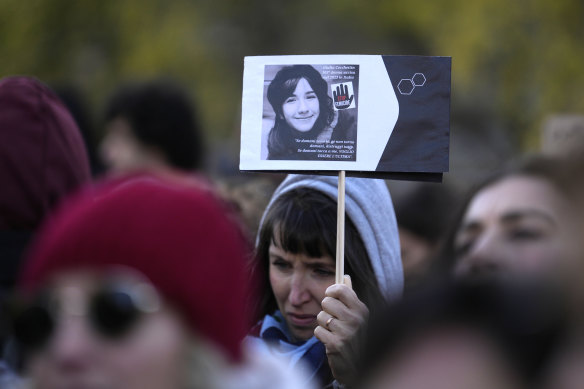 A woman shows a photo of Giulia Cecchettin, allegedly killed by ex-boyfriend, in Milan on Saturday,.