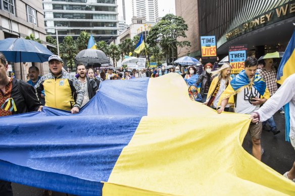The Ukrainian flag is carried along Elizabeth Street in Sydney during the Stop War in Ukraine rally.