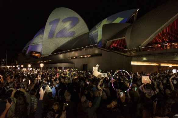 Protesters opposing the projection of material promoting The Everest horse race onto the sails of the Opera House.