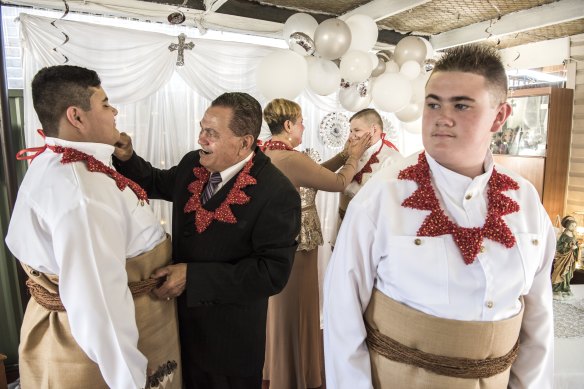 Left to right: Emelio Simpson, Christopher Vaka’uta and Jaiah Simpson preparing for their confirmation and first Holy Communion. They are helped by their grandparents Emelio and Velonika Vaka’uta and wearing traditional Tongan dress to reflect their heritage.