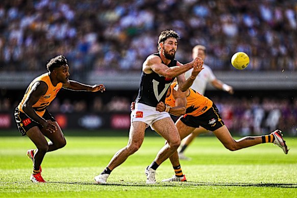 Lachie Ash of Victoria handpasses the ball.