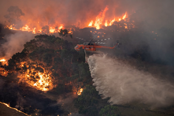 A firefighting helicopter tackling a bushfire near Bairnsdale in Victoria’s East Gippsland in December 2019.