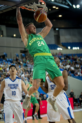 Boom time: Australia's Mitch Creek slams home a dunk against against Chinese Taipei.