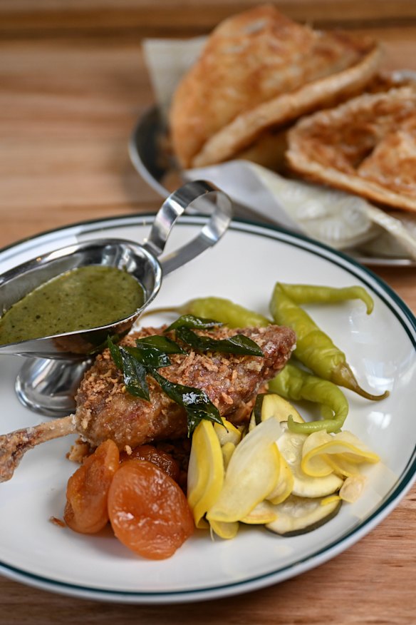 Apricot and macadamia duck leg with native green curry gravy, roti and pickles.