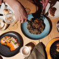 Fire-roasted whole baby pumpkin with mushroom risotto (centre right), and kingfish tiradito.