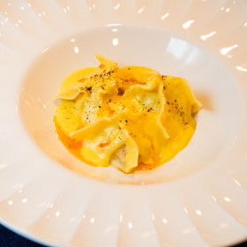 Dumplings in creamy corn sauce. 
