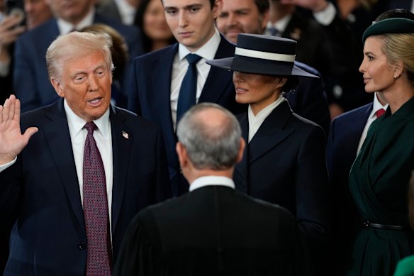 Donald Trump is sworn in as the 47th president of the United States by Chief Justice John Roberts as Melania Trump holds the Bible.