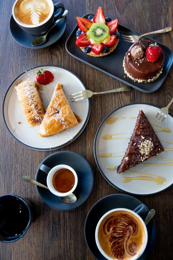 Sweets including walnut and syrup cake, baklava, fruit tart, and chocolate and strawberry cake.