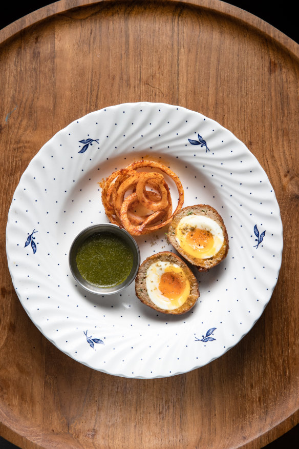 Chicken scotch egg with spicy onions.