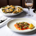 Clockwise from top left: Clams casino, crumpets and Ora King salmon gravalax at Bistro George in Sydney.