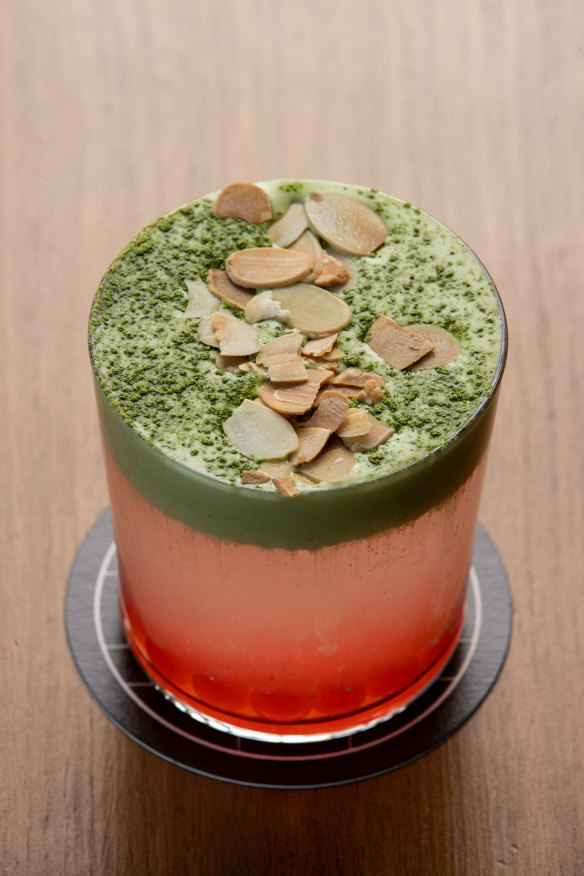 Coco Cloud drink with coconut water, pomegranate pearls, matcha cream and flaked almonds.