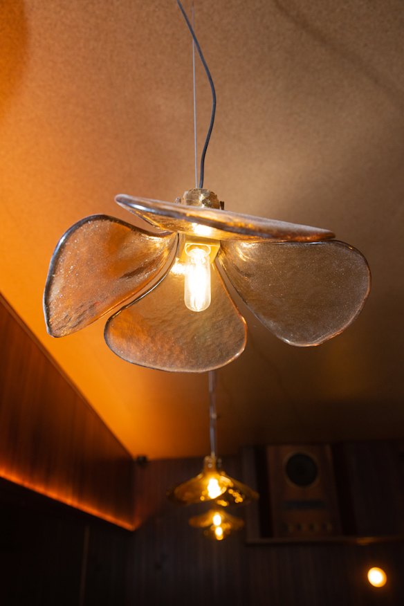 Lily-shaped glass pendant lights soften the space.