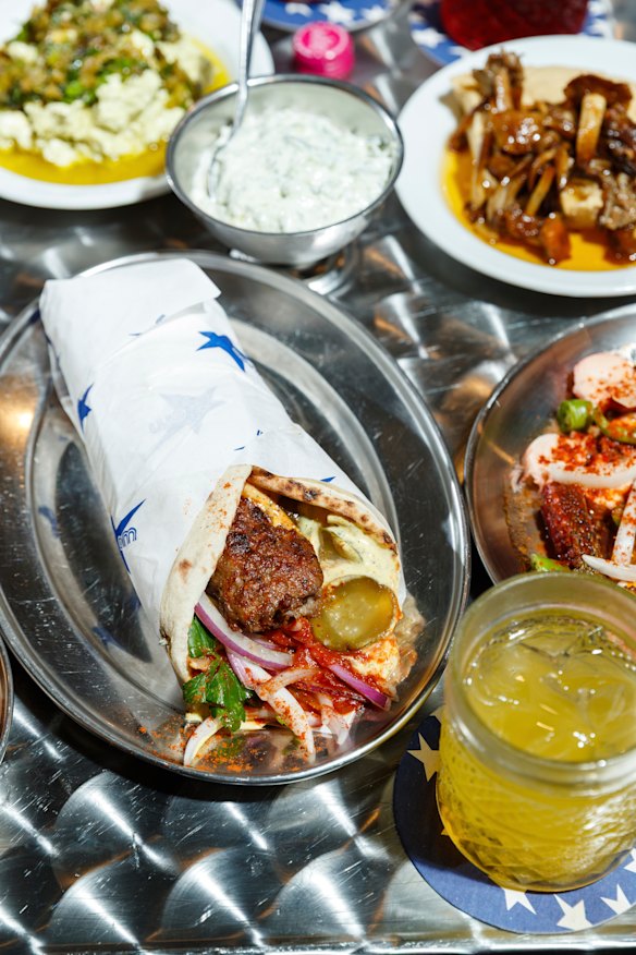 Politiko kebab pita with beef and lamb, with side dishes.
