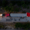 In this aerial view, members of law enforcement investigate a semitrailer on San Antonio, Texas. Officials found 46 migrants dead inside.