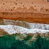 Beachgoers enjoy the crystal clear waters at Palm Beach.