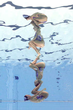 Australians Emily Rogers and Amie Thompson compete in the artistic swimming duet technical routine in Tokyo on Tuesday. Much of their time is spent under water and holding their breath.