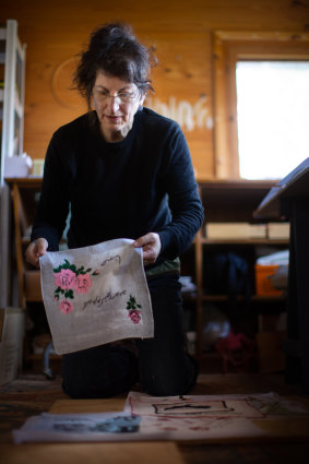 Gali Weiss with examples of the handkerchief artworks created for <i>Making Marks</i>.