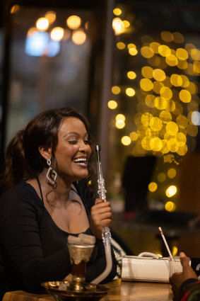 Diners enjoy smoking shisha after a meal at Cairo Nights.