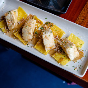 Golden tofu on crispy wonton with crushed peanuts.