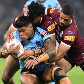 Brian To’o of the Blues is tackled during game three of the State of Origin Series