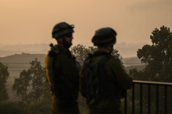 Members of the Israel Defence Force look out towards Gaza, as seen from the border area near Sderot, Israel.