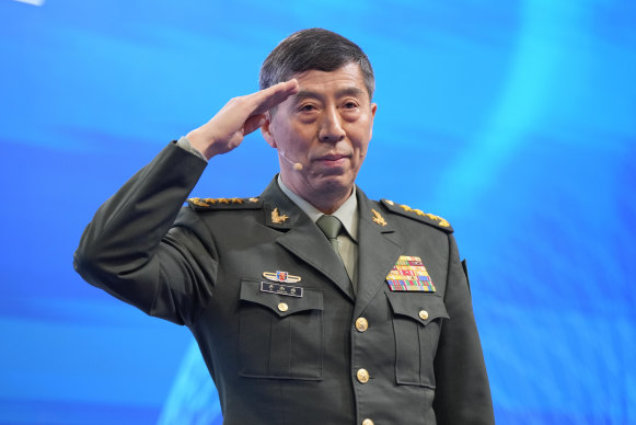 Chinese Defence Minister Li Shangfu salutes before delivering his speech in Singapore.