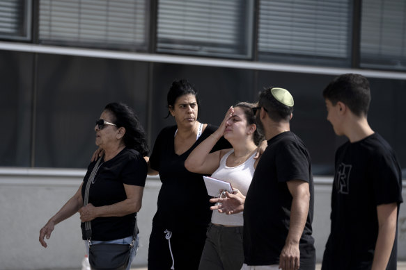 An Israeli family arrives to a police station in Lod, Israel, to provide DNA samples to help identify a relative missing since a Hamas militant attack near the Gaza border.