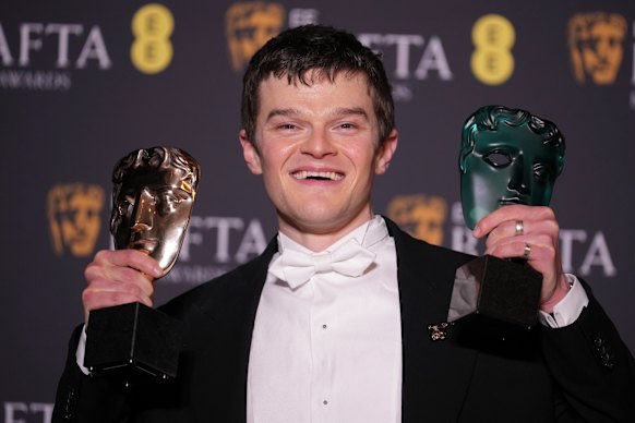 Robert Aramayo poses with his EE rising star award and the award for leading actor for I Swear at the BAFTAS on February 22. 