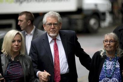 Rolf Harris arrives for his trial at Southwark Crown Court in London in 2014 with his wife Alwen Hughes, right, and his daughter, Bindi.