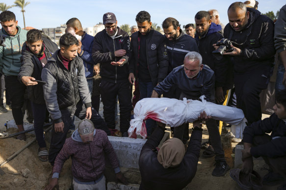 Palestinians bury the body of a young relative who was killed in the Israeli bombardment of the Gaza Strip on Tuesday.