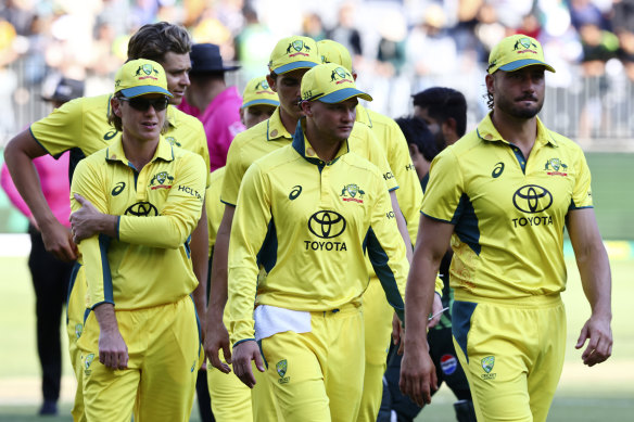 Australian players walk off the pitch after their loss to Pakistan.