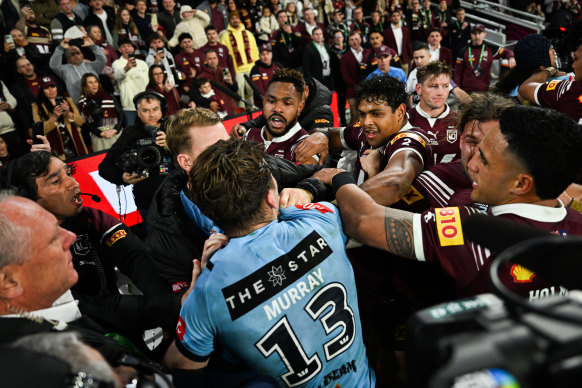 Cameron Murray runs into a sea of Maroons players to fight from the bench.