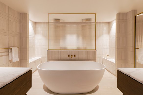 The large bathroom has double sinks and showers, a freestanding bath and art-deco-style fluted glass and gold accents. Plus ESPA toiletries and a Dyson hairdryer.