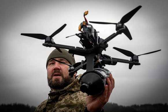 A Ukrainian soldier demonstrates a locally-made drone in the Kyiv region.