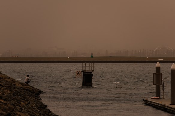 A fisherman at Port Botany as the Southerly winds reach Sydney.