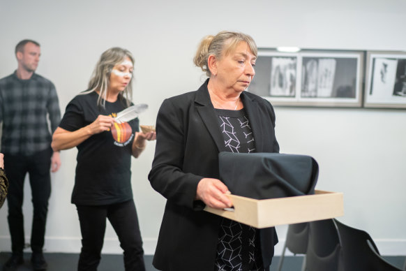 Wendy Dalitz, the assistant director of Indigenous Repatriation for the Australian government, carries the remains of First Nations ancestors during the ceremony.