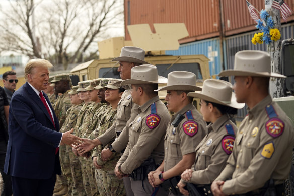 Donald Trump greets members of Texas Department of Public Safety as he visits Shelby Park on the US-Mexico border.