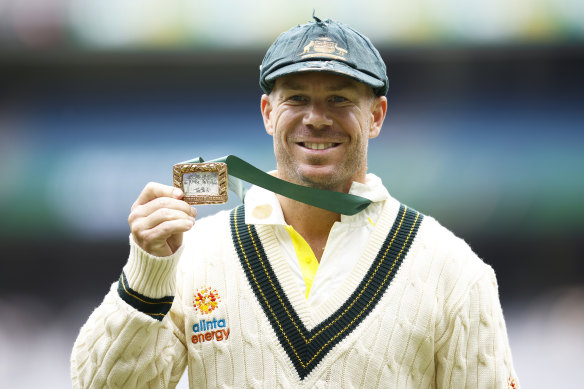 David Warner of Australia holds the Mullagh Medal after being awarded player of the match.